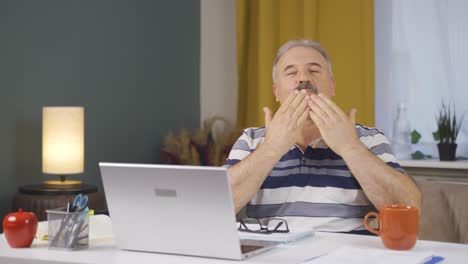 home office worker old man looking at camera clapping and getting excited.