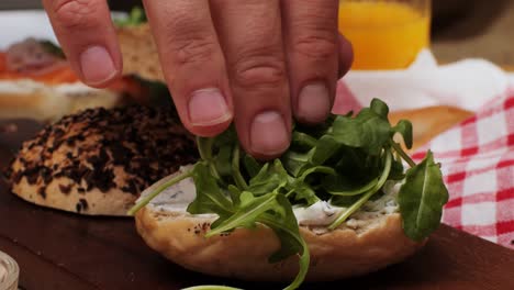 bagel sandwich brunch, lunch plate of a bagel with smoked salmon and cream cheese and ham, close up morning cafe menu.