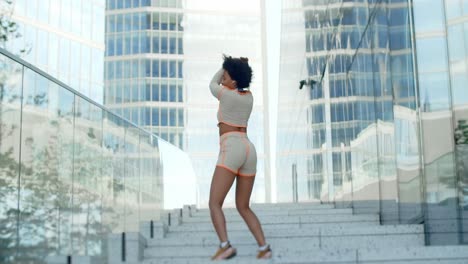 woman dancing on stairs in city