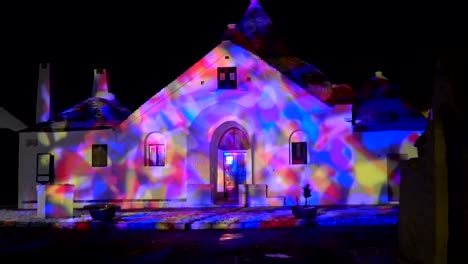 night shot of trullo sovrano in alberobello italy during christmas time