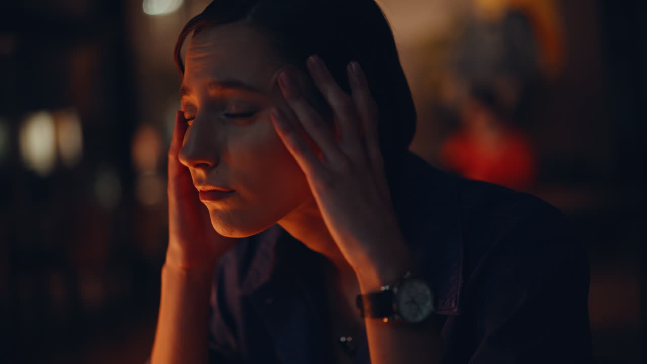 Closeup fatigued night worker touching temples finishing hard workday portrait