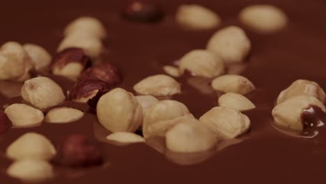 slow motion of hazelnuts dropping into hot chocolate