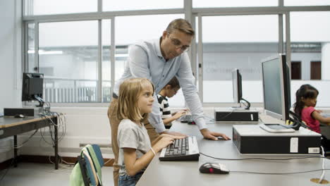 Girl-sitting-at-table,-looking-at-keyboard-with-surprise-and-typing