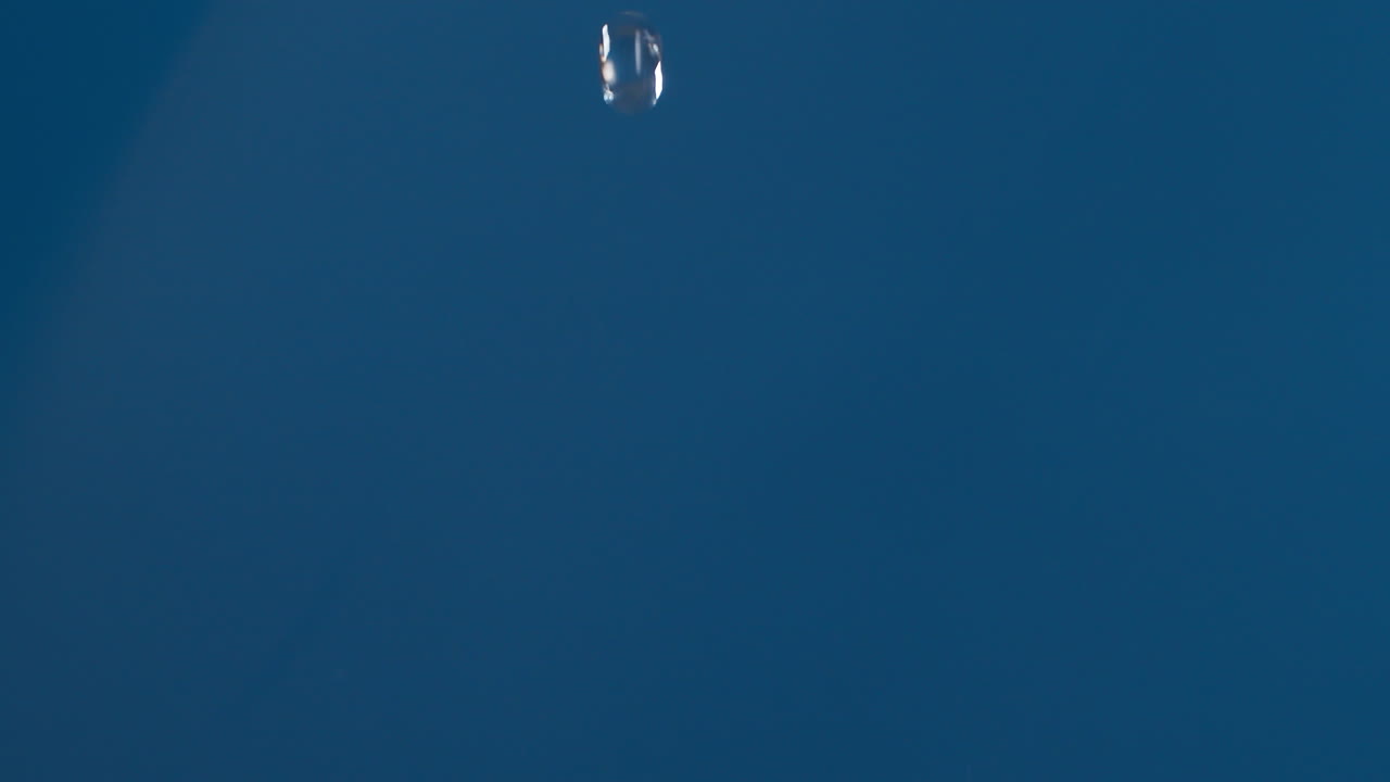 슬로우 모션으로 촬영하는 파란색 배경에 물이 튀면서 흐르는 진짜 순수한 물