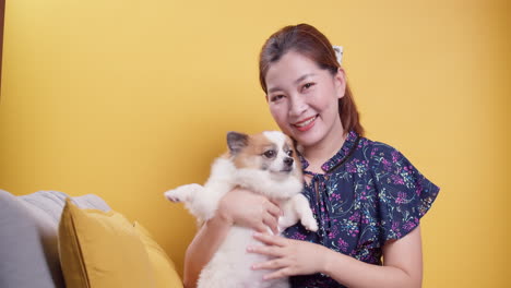 asian women play with puppy pets hold a