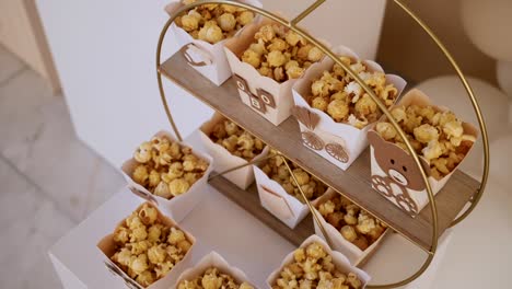 adorable baptism table decor with popcorn and bear-themed packaging