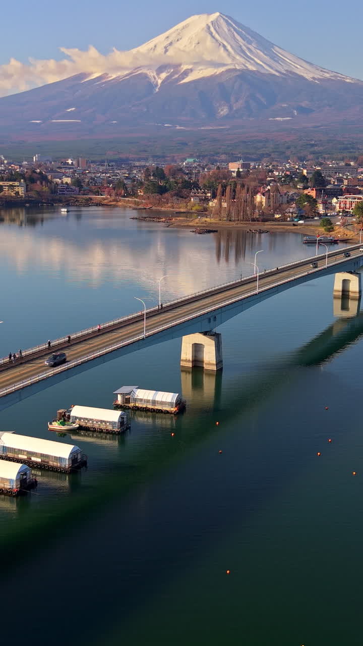 Aerial drone view of the Kawaguchiko-Ohashi bridge near the Fujikawaguchiko town in Japan with Mount Fuji on the background