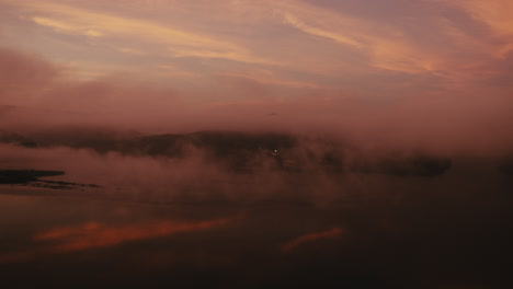 misty sunrise/sunset landscape over water