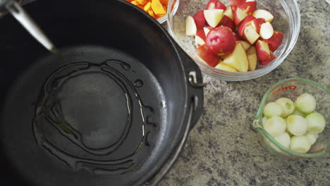 drizzling oil into a hot cast iron pot