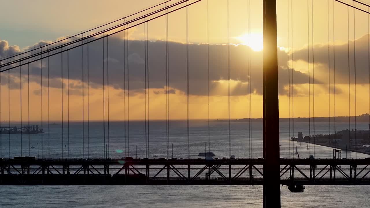 Sunset Sky Over 25 Of April Bridge At Lisbon In Lisbon District Portugal. Sunset Downtown. Freeway Road Landscape. 25 Of April Bridge At Lisbon In Portugal. Railroad Scenery