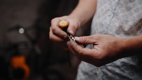 Close-up-shot-of-mechanic-slowly-opening-up-a-chain-lock-with-a-screwdriver