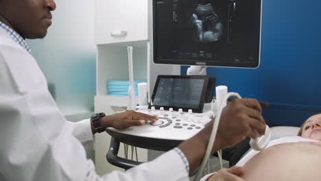 doctor performing ultrasound on pregnant patient