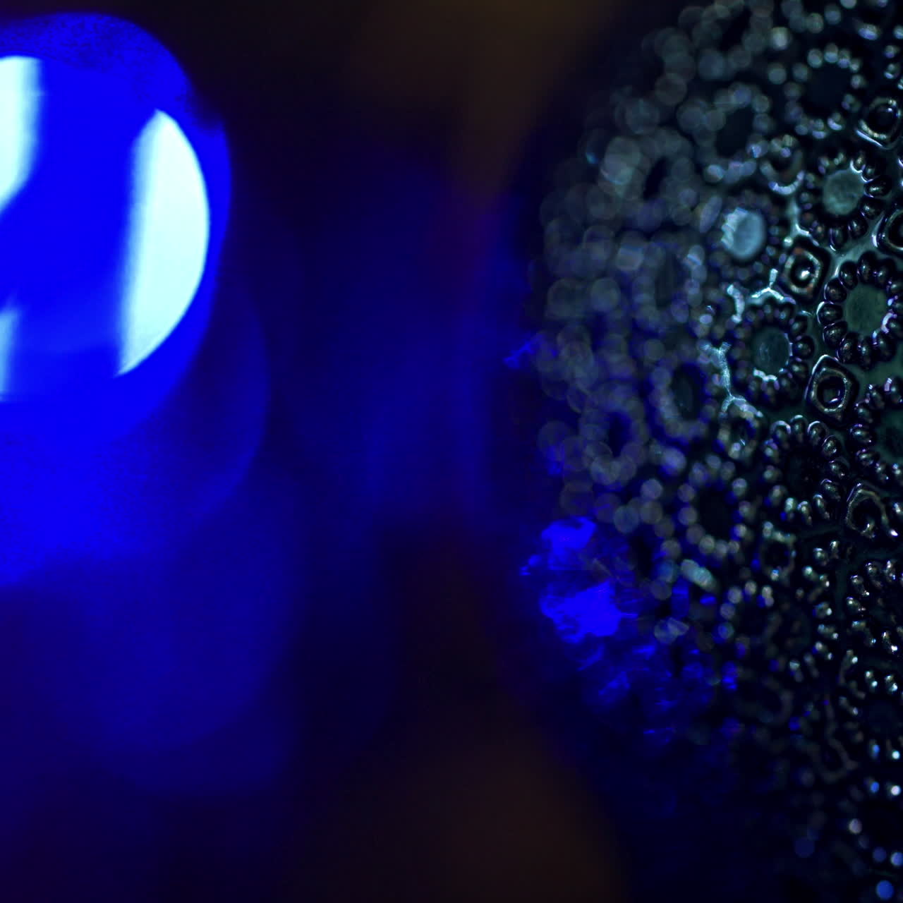 Christmas toy on blinking background. Some part of New year's decoration with blue light twinkling from the garland indoors.