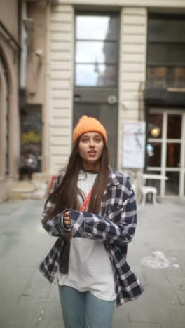 woman in orange hat on city street