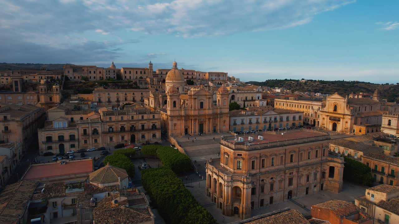 Noto’s Cathedral of San Nicolò and surrounding baroque buildings. Scenic aerial sunset drone. Sicily