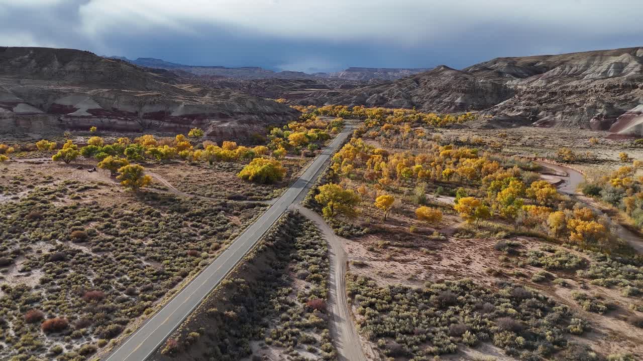 Aerial View of Scenic State Route and Yellow Trees on Sunny Autumn Day in Desert Landscape of Utah USA