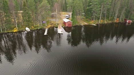 Trees-With-Mirror-Reflections-On-Calm-Lake-Water-During-Autumn-In-Sweden