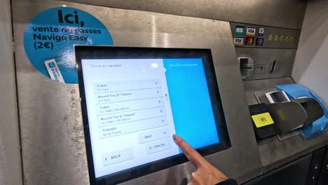 person interacting with a digital ticket machine