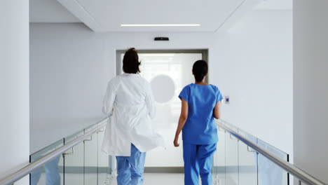 doctor and nurse running in passageway of hospital