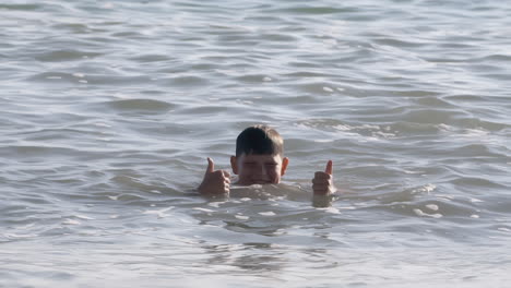 happy boy swimming in the ocean