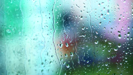 wet window with raindrops. water drops moving down on glass window on blur view background. close-up.