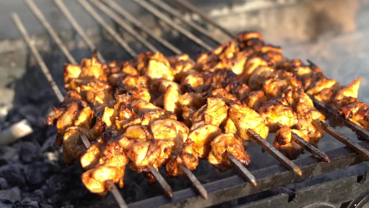 A person grills chicken close up shot, insert shot