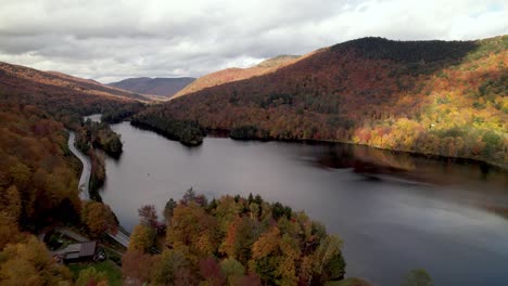 new england autumn leaf color over lake in vermont