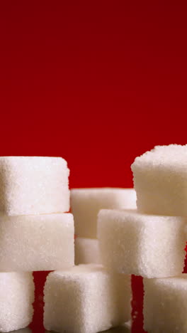 sugar cubes on red background