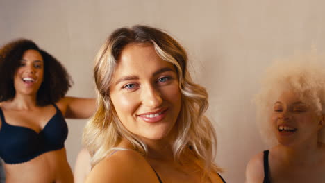 group of women friends in studio wearing underwear promoting body positivity dancing