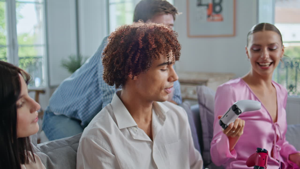 Friends taking joysticks playing video game at home closeup. Gamers competing