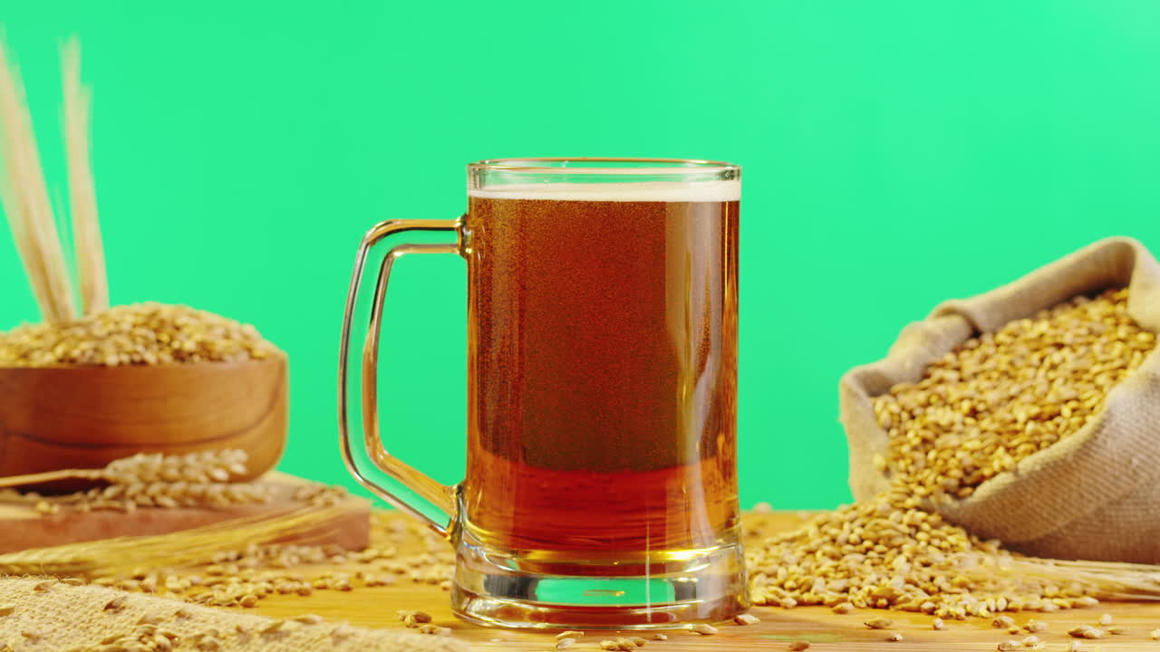 A glass of beer with wheat and barley