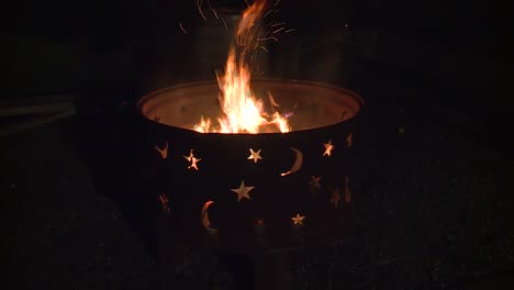 Fire-burning-in-a-fire-pit-at-night