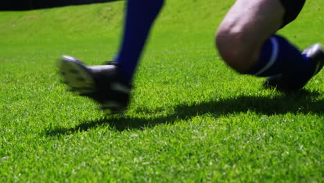 football player striking a ball in the field