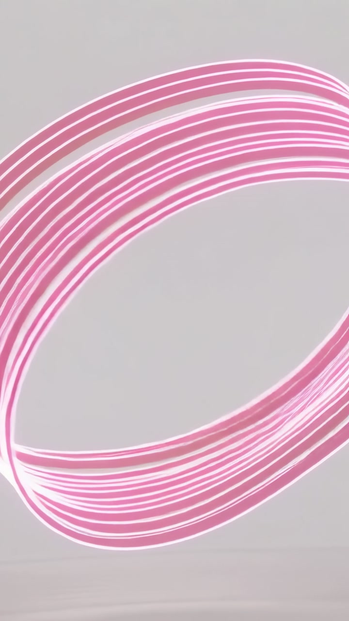 Vertical video: Starting animation pink ribbon coil rotating, morphing to reveal interior on studio