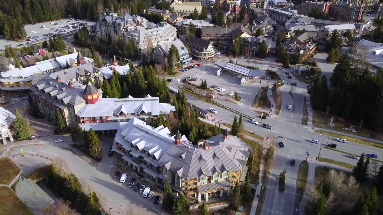 Cars and bus traffic driving at Whistler resort town in BC, aerial tilted view