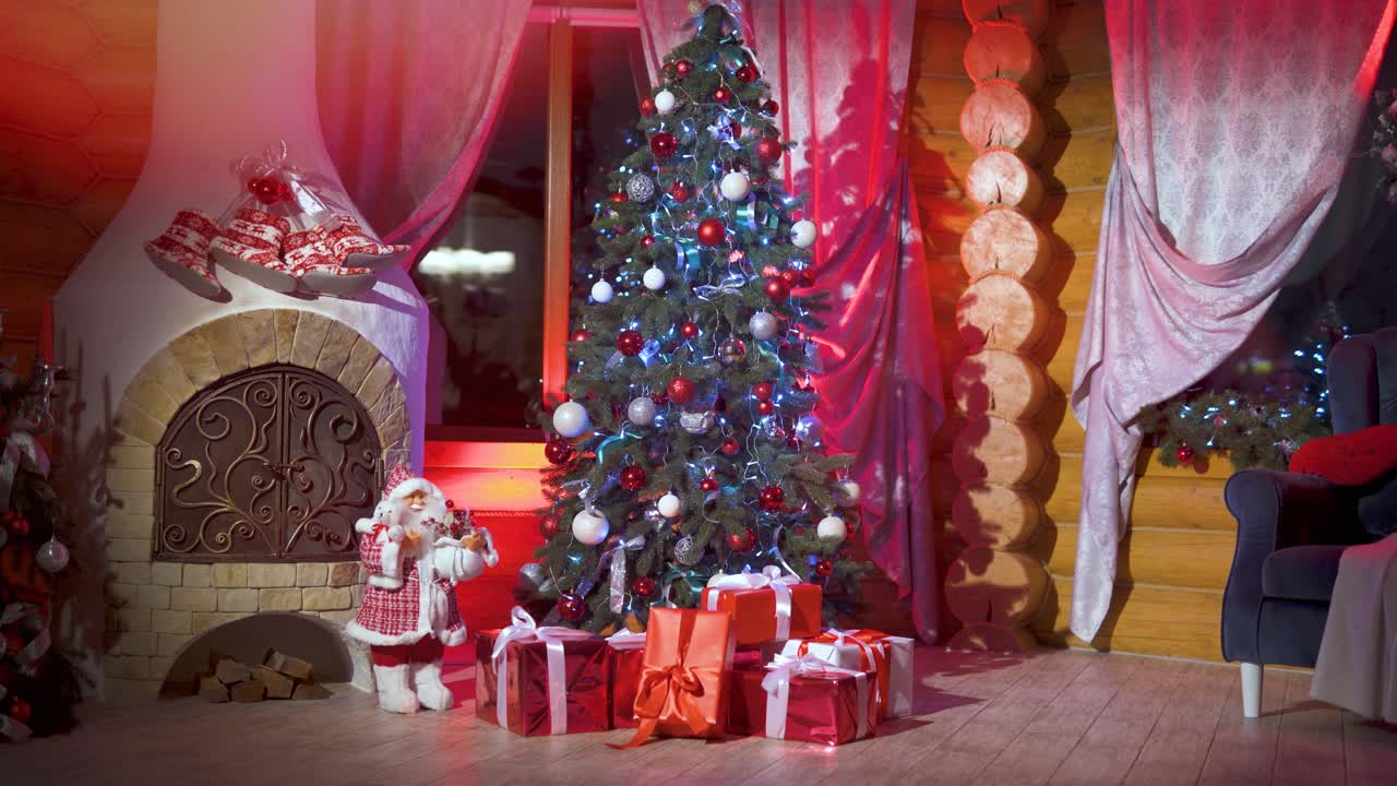 Christmas tree with decorations and New Year's gifts in boxes in a big house with a fireplace. Light leaks and flare from the festive illumination. Happy holyday celebrations