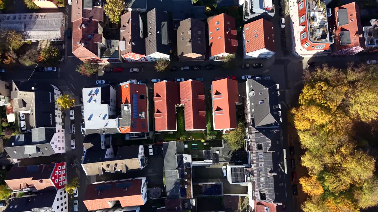 Aerial top down flyover townhouse and row of homes in american city at sunny day. Colored trees in fall season. Dense populated housing area in USA