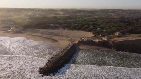 Breakwater-of-Luna-Roja-beach-at-sunset,-Chapadmalal-in-Argentine