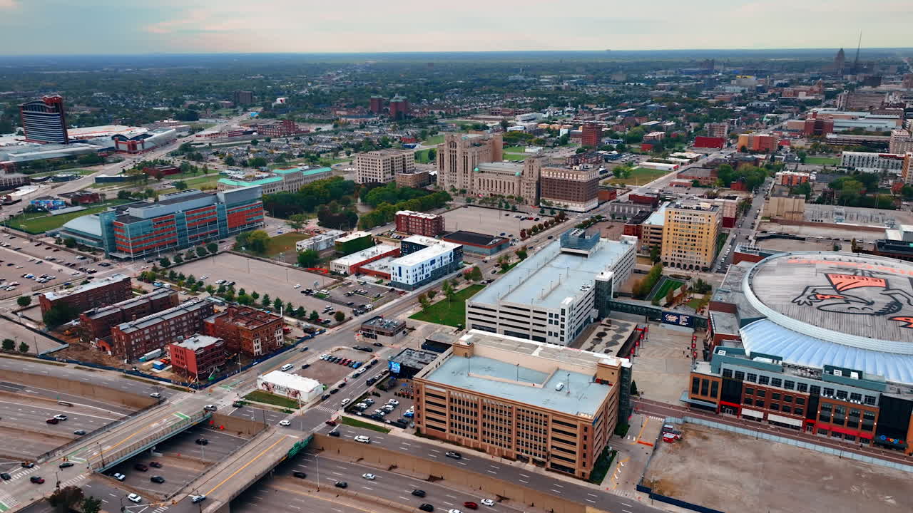 Detroit, USA, 11 August 2025: Aerial panorama of Detroit's urban core. Renaissance Center towers rise amid stadiums and parking lots under cloudy skies