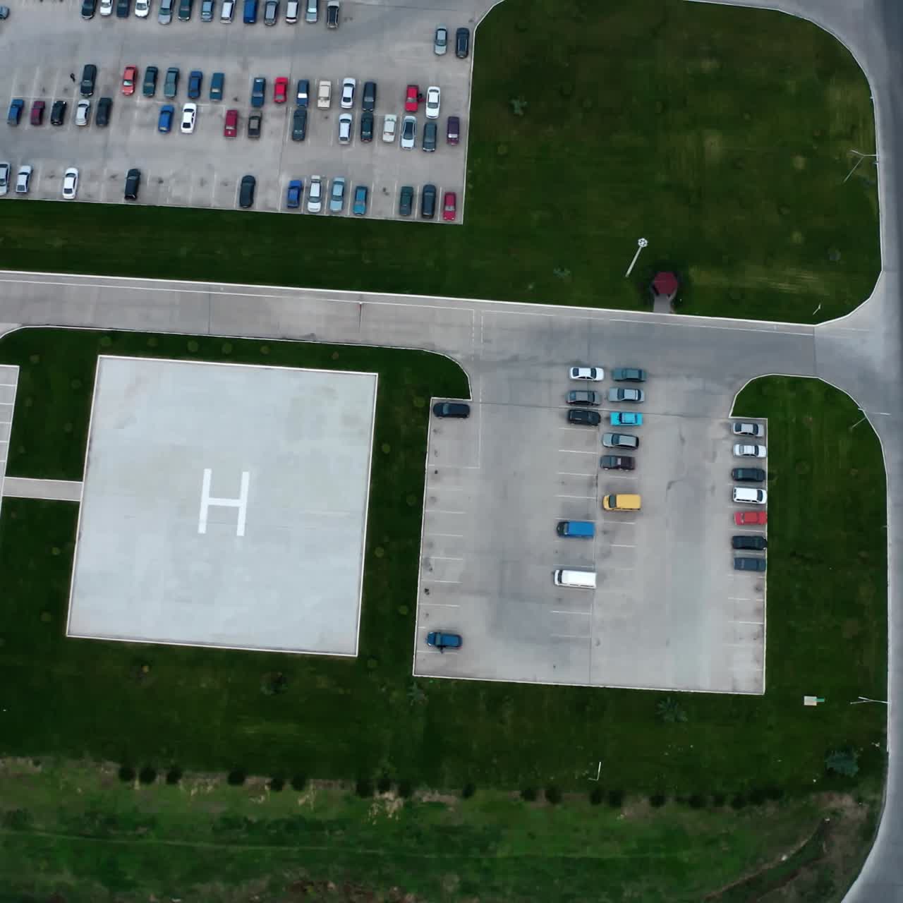 Car parking on field. Industrial territory and many cars nearby. Colorful cars on the parking zone. Top view.