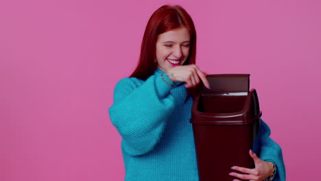 Happy-redhead-teen-girl-in-blue-sweater-taking-off,-throwing-out-glasses-after-vision-treatment