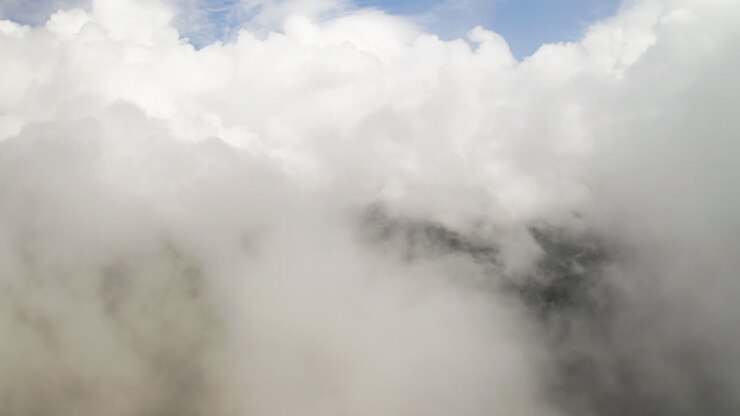 Soothing serene natural background of clouds over forest, aerial drone establishing