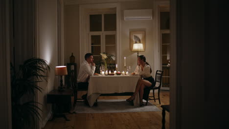 loving couple romantic evening at home. lovers enjoying dinner with candles