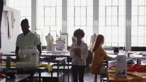 three colleagues working separately in fashion office