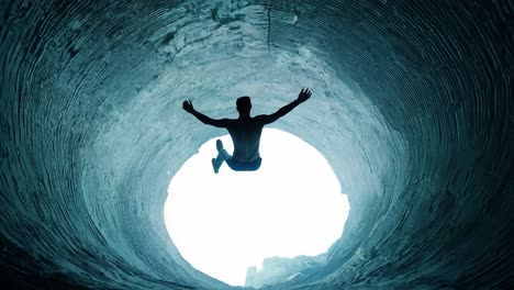 athlete jumping into water creates a striking contrast of bright light emerging from a dark environment