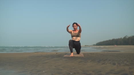 yogi doing yoga on the sunny beach, reaching for the sky