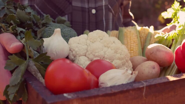 Man carrying box of vegetables