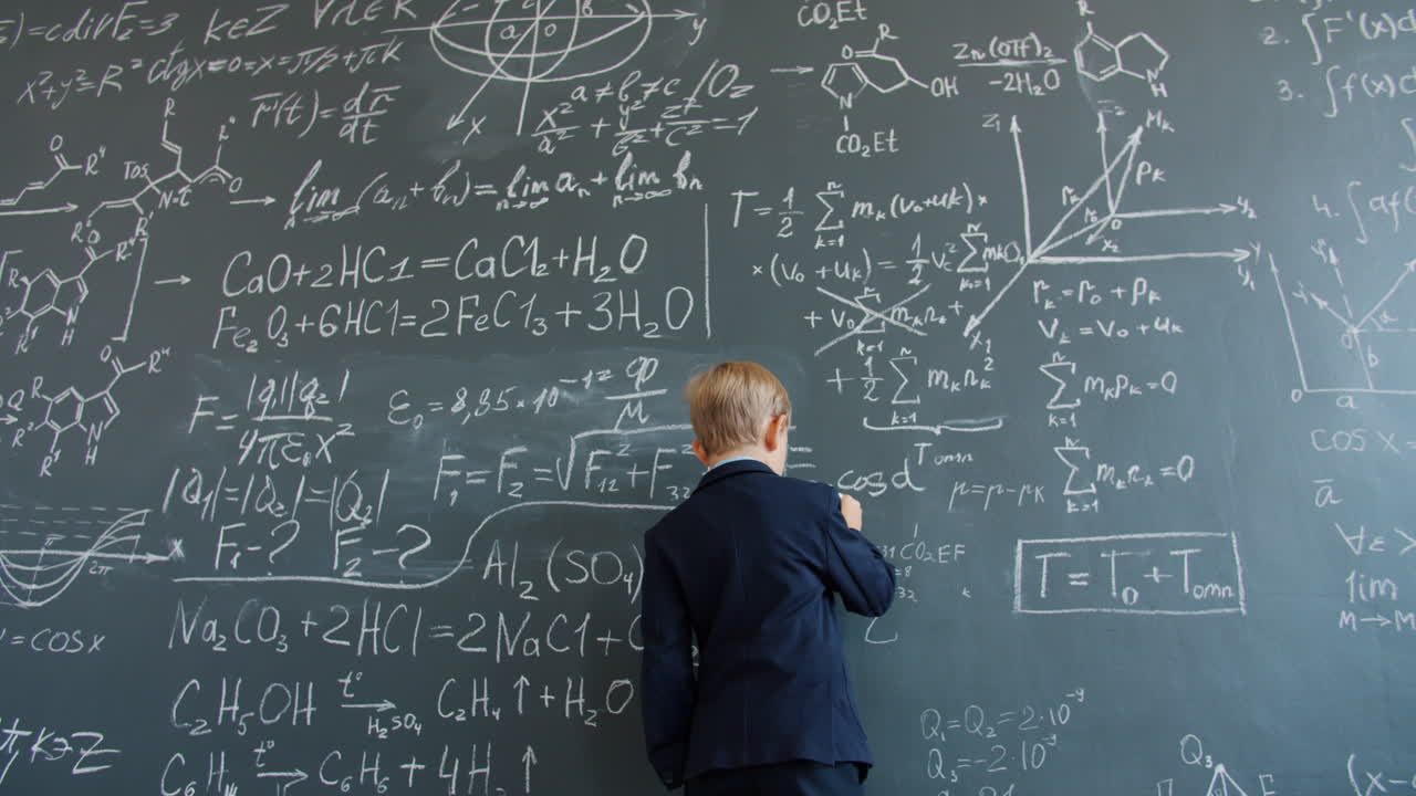 Boy Studying Math on a Chalkboard