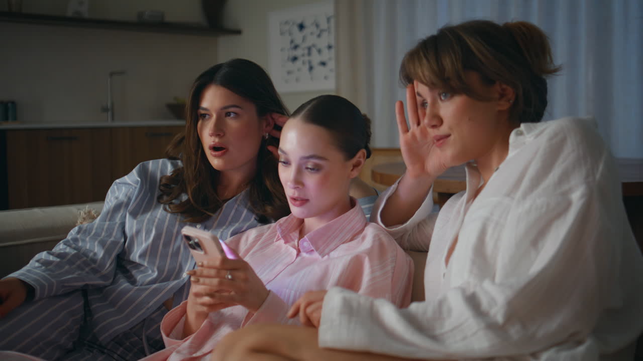 Women enjoying home sleepover sitting home sofa closeup. Relaxed female friends