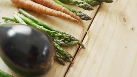 video of fresh vegetables with copy space over wooden background